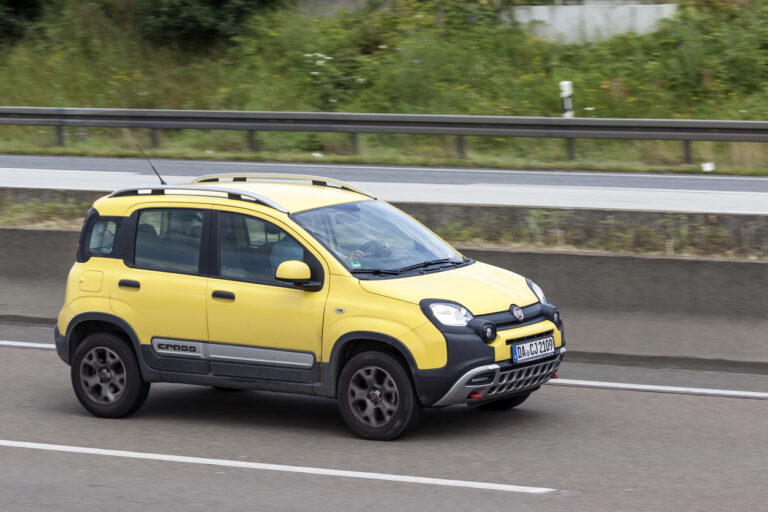 Der gelbe Fiat Panda fährt über eine Autobahn.